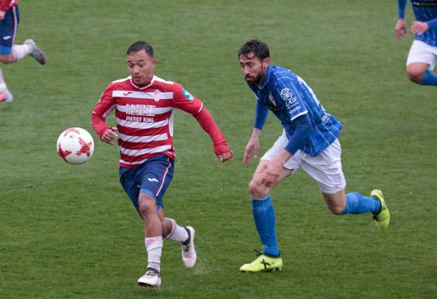 Despeje de la defensa rojiblancas ante el acoso murciano, a la izquierda, mientras Juancho se escapa con el balón de la marca de un rival. /Alfredo Aguilar